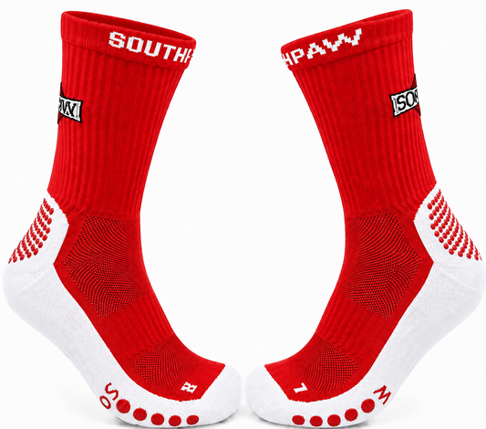 A pair of red and white athletic crew socks with grip dots on the toes, featuring 'SOUTHPAW' white branding on the cuffs, shown against a white background.